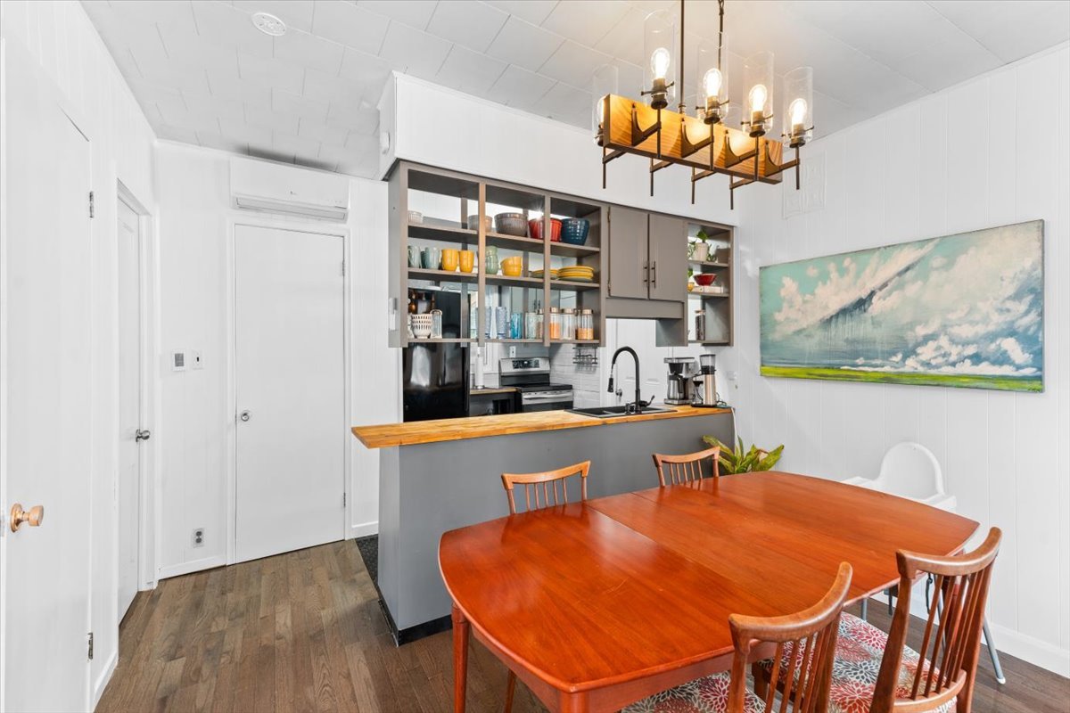 A bright white kitchen and dining room with wood accents