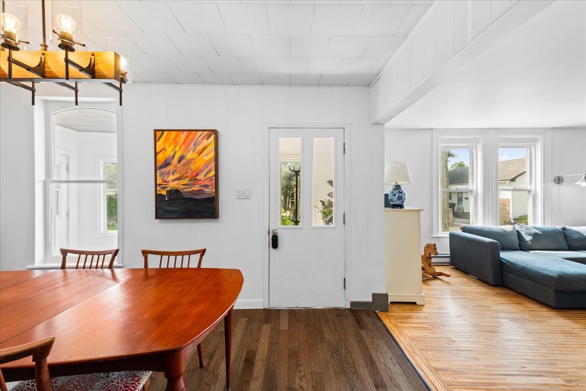 A crisp white entryway opening into a sunlit living room